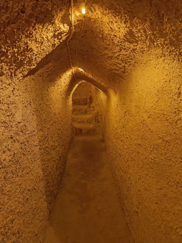 Cappadocia Underground City Tour Tourists exploring the narrow tunnels and ancient rooms of an underground city in Cappadocia.