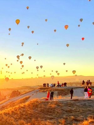 Cappadocia hot air balloon panorama view at sunrise with balloons flying over fairy chimneys