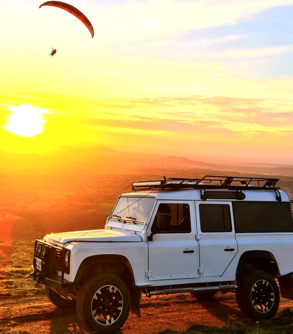 Cappadocia Jeep Safari Adventure Tourists enjoying a thrilling jeep safari through the rocky valleys and dusty trails of Cappadocia.