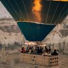 Colorful hot air balloons flying over the fairy chimneys of Cappadocia at sunrise.
