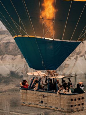 Colorful hot air balloons flying over the fairy chimneys of Cappadocia at sunrise.