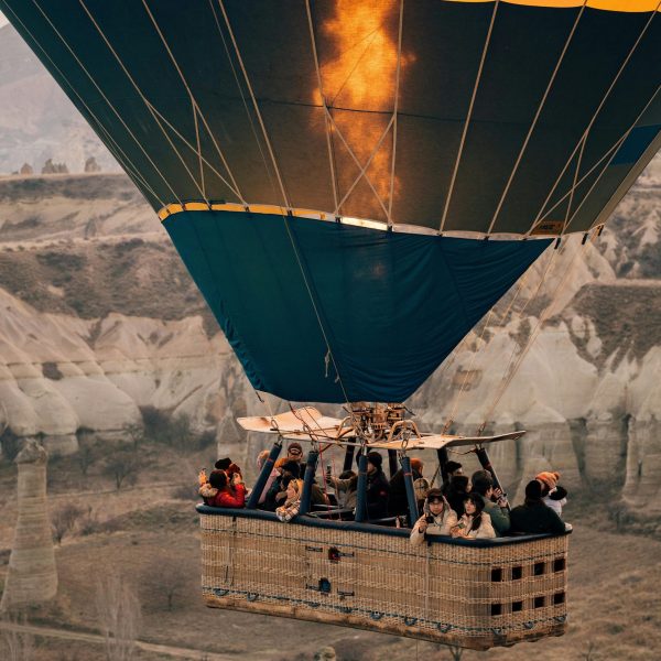 Cappadocia Hot Air Balloon Tour Colorful hot air balloons flying over the fairy chimneys of Cappadocia at sunrise.